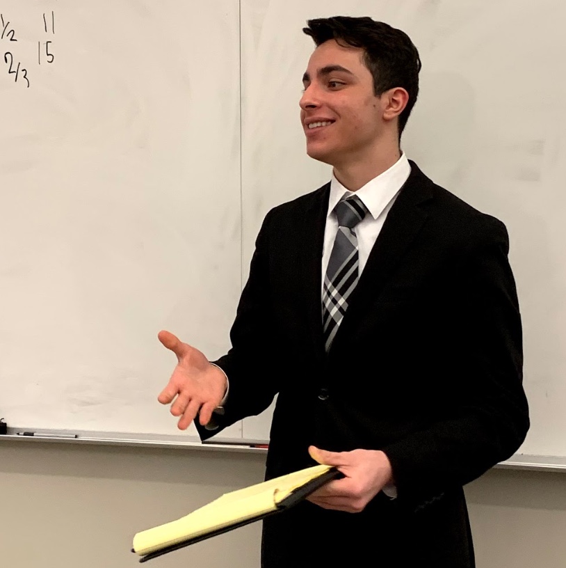 Jefferson%E2%80%99s+Congressional+Debate+captain%2C+Dany+Matar%2C+smiles+at+his+audience+as+he+finishes+his+first+speech+in+the+2018-2019+Metrofinals+competition.