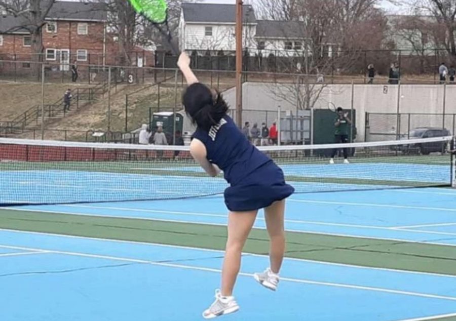 Freshman Allison Seo jumps in the air to hit the ball during a game against Wakefield High School on March 13.