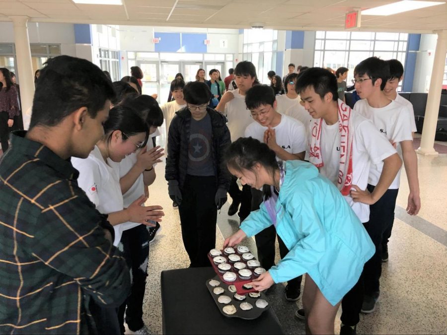 Sophomore Zia Sun unveils the cupcakes she baked for the Chiben students as they watch in surprise after the final performance.