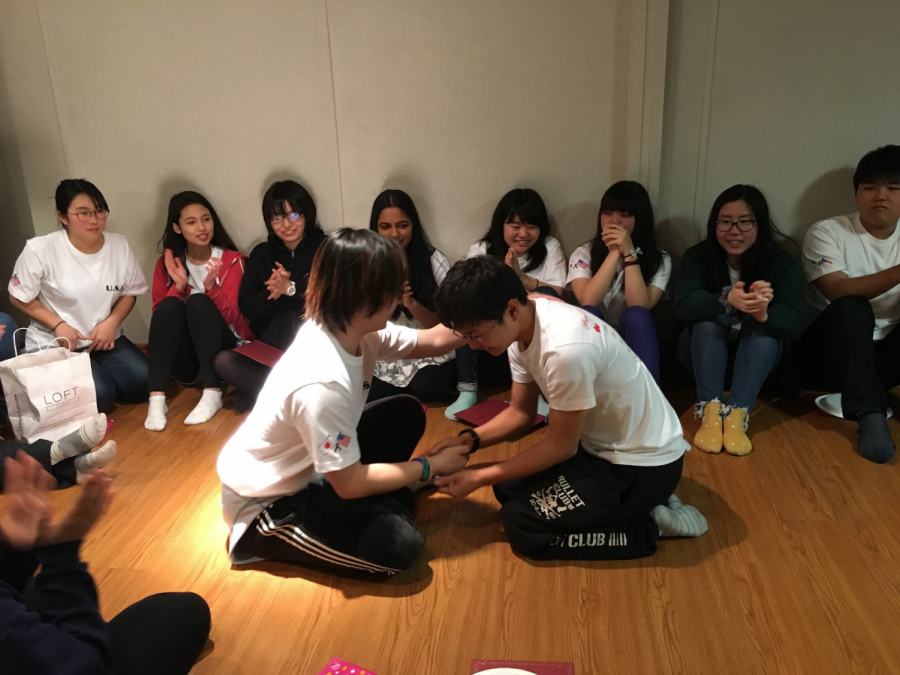 Junior Robyn Chang comforts her exchange student, Chiben Gakuen Wakayama first-year Shingo Haruta, as the two say their goodbyes at the farewell party. “I was sad that [Shingo] was leaving but I wasnt that sad because I knew I could still talk to him [via social media],” Chang said.