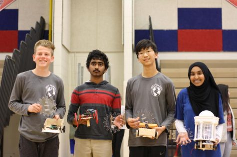 Freshmen Ryan Angle, Junho Lee, Akshan Sameullah, and Isra Satiar pose with their trophies and robots. They won the maze, torque, speed, and beauty competitions. 