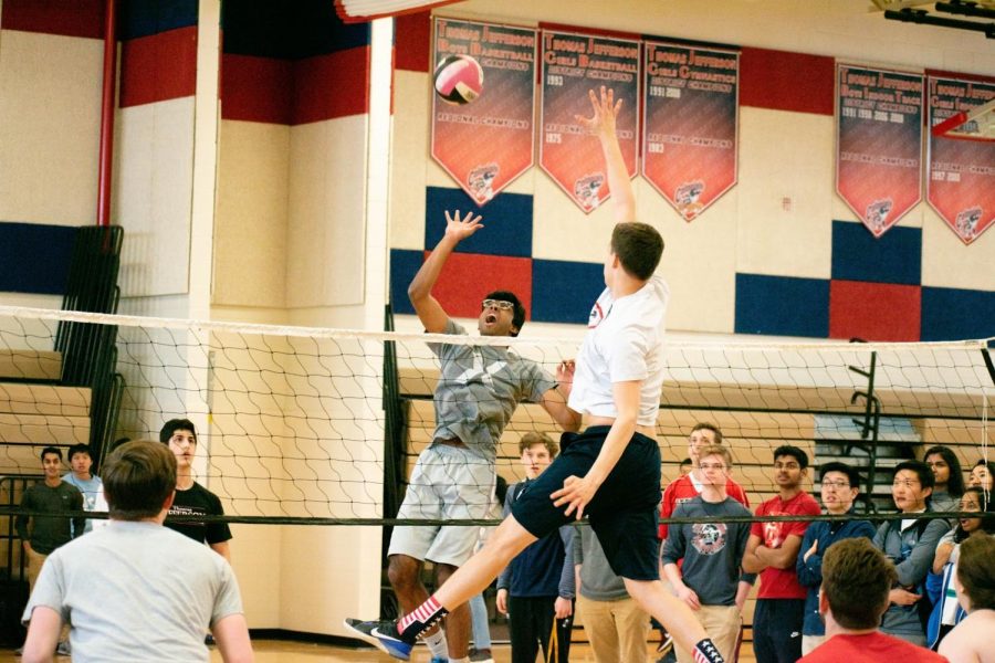 Senior Ankit Badatala reaches for a spike over senior Max Graves during the March Mania tournament. Photo courtesy of Forrest Meng.