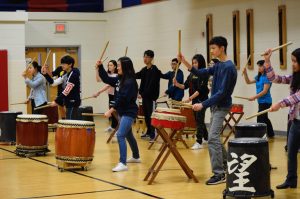 Determined and concentrated at the task at hand, students under the guidance of taiko artist Mark H. Rooney prepare to strike the taiko drum. Students both interested in Japanese culture and involved with the Japanese program attended a workshop on Friday, March 22 to immerse themselves in the Japanese culture. 