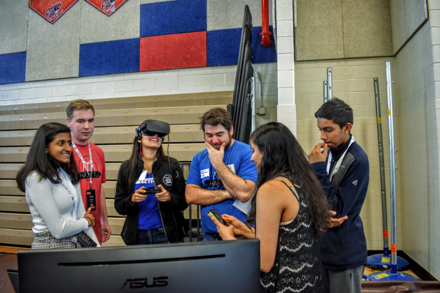 Working with virtual reality at HackTJ, junior Rhosini Raghuraman attentively takes in the presentation. "At HackTJ we wanted to revolutionize civic education and we made a VR game that taught people about the legislative process. We went into it not knowing Unity or how to work Alienware but we pulled through," Raghuraman said when asked what her favorite part of HackTJ was. As a women interested in STEM, Raghuraman, was one of the girls making up the 1:3 girl-boy ratio of participants present at HackTJ.