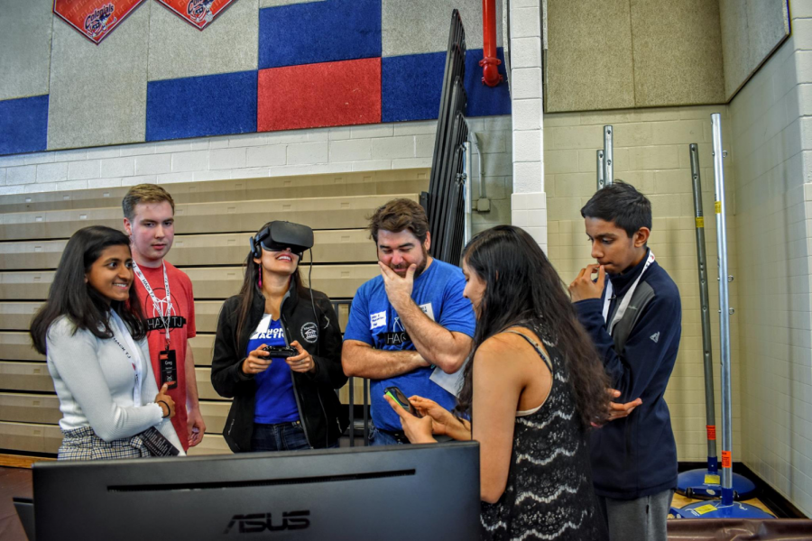 Working with virtual reality at HackTJ, junior Rhosini Raghuraman attentively takes in the presentation. At HackTJ we wanted to revolutionize civic education and we made a VR game that taught people about the legislative process. We went into it not knowing Unity or how to work Alienware but we pulled through, Raghuraman said when asked what her favorite part of HackTJ was. As a women interested in STEM, Raghuraman, was one of the girls making up the 1:3 girl-boy ratio of participants present at HackTJ.