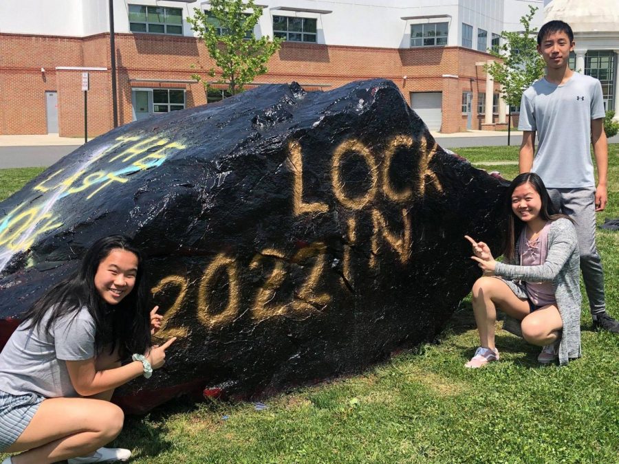 2022 class council members Caroline Chen (far left), Melissa Wu, and Leon Jia stand beside the rock outside Jefferson after they painted it for the lock-in. Even though there will no longer be a freshman lock-in, they're hopeful that a similar event will replace it.  "I feel like [admin will] be able to find ways to make up for [lock-in], like make a new event or host something else," Chen said.