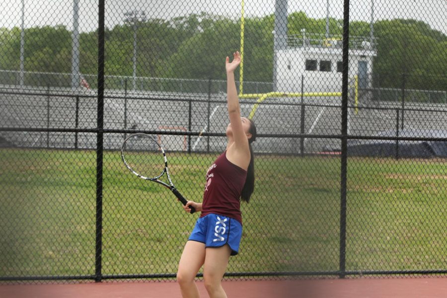 Senior Joyce Liu prepares to serve to her opponent.