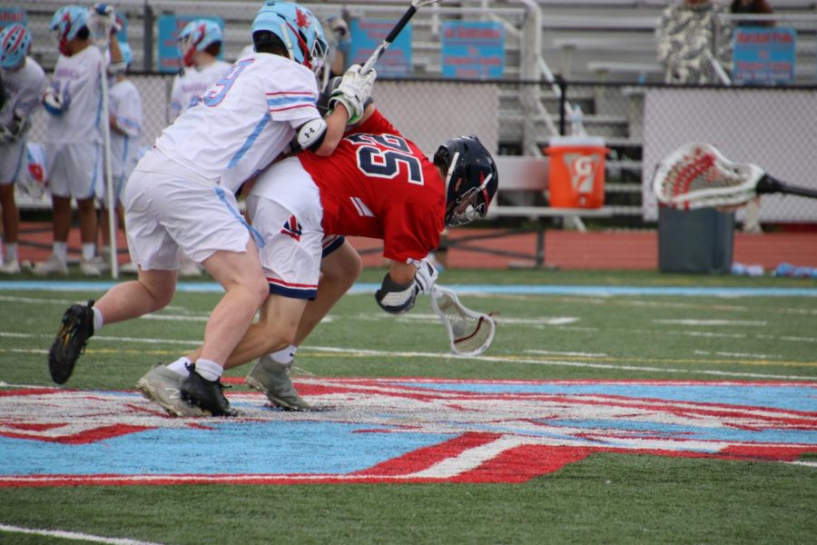 Bending over to dodge an opponent, midfielder Caden Philips battles to maintain possession. The teams efforts ultimately werent enough as they lost 11-7.