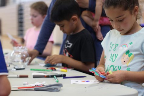 Kids at the Project Caelus booth create straw rockets which they can launch by blowing air into straws.