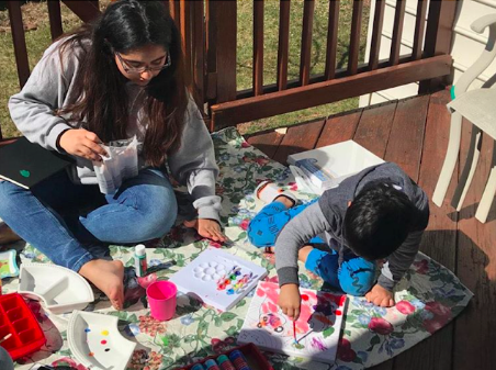 Photo courtesy of Manya Phutela. Chantilly High School freshman Manya Phutela paints with her brother on a sunny day. “[After leaving Jefferson], I get to hang out with my brother every day, which wasn’t possible at Jefferson, and it makes me so happy!” Phutela said.