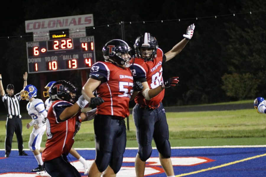 A group of Colonials celebrate after scoring a touchdown during last Septembers Back to School Bash game