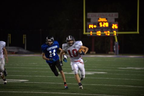 Rushing ahead of the Centurion defender, halfback Sherzoy Jan (10) rushes for a 43-yard touchdown. The score brought the Colonials within one touchdown of the Centurions.