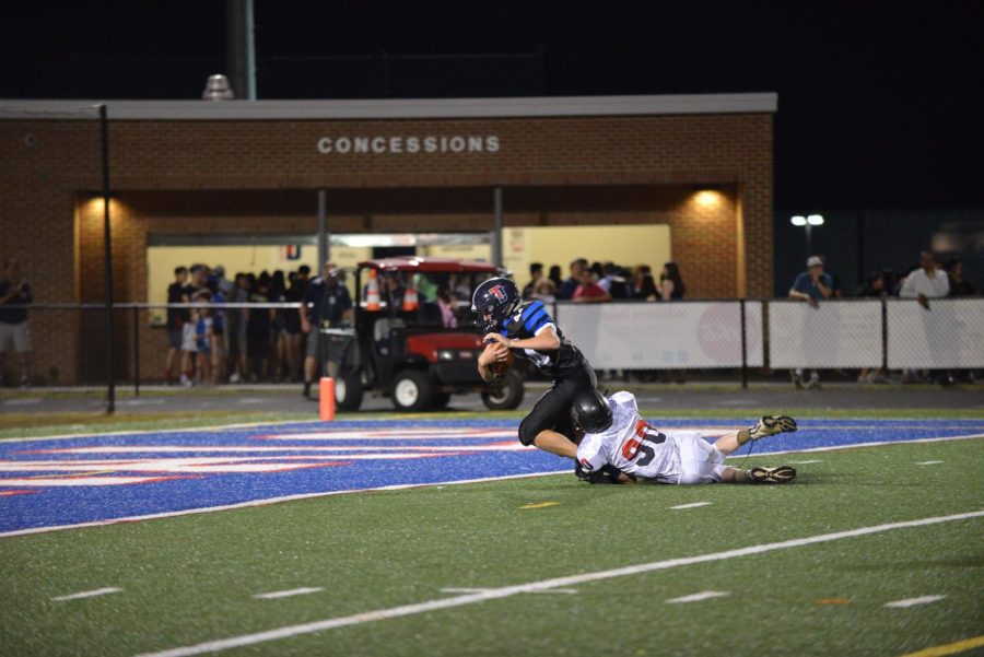 Diving into the General’s endzone, tight end Caden Philips (44) scores the Colonials’ third touchdown of the game