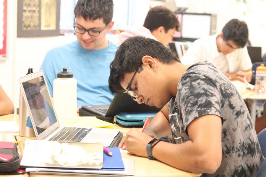 In a mixed grades BC class, a student works on his math classwork.