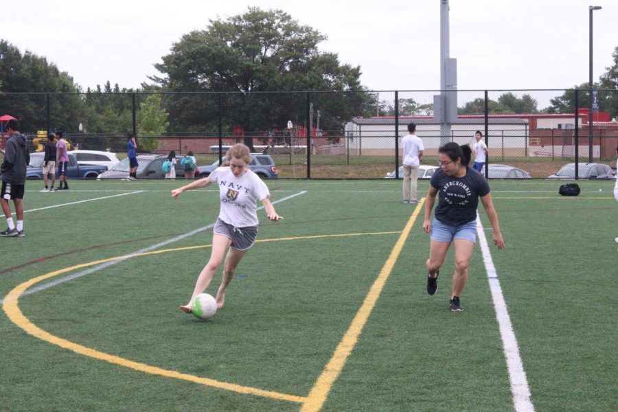 Shea Weingold kicks a soccer ball and Jenny Li waits for the ball to come her way. Students played soccer, volleyball, and tug of war during the Bash. Spending fun time with friends after a stressful week is one of the largest reasons students decided to attend the Bash. 


