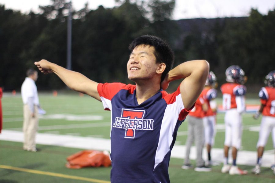 Justin Choi smiles while hitting a motion in a cheer. Cheer is a really rigorous sport, so sometimes you feel completely exhausted, but I always leave feeling happy and excited, Choi said. 