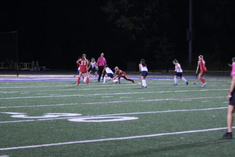 Senior Rithika Murugesan stands ready to receive the ball while another team member fights to keep the ball away from the opposing Annandale Atoms Varsity Girls Field Hockey team, after senior Aastha Mistry scored the first goal for the Colonials. The Colonials won a 1-0 victory against the Annandale Atoms. 