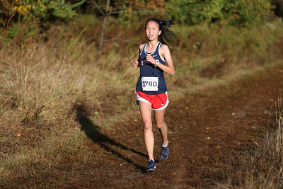 Sophomore Ashley Chen runs on the track at the JV district meet. There were three teams present at the meet. I get to meet new people, and we have spirit days. Its a lot of fun, Chen said when asked what her favorite part about cross-country is.