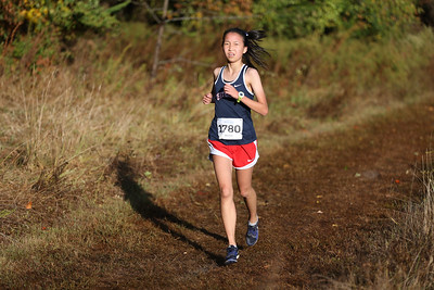 Sophomore Ashley Chen runs on the track at the JV district meet. There were three teams present at the meet. "I get to meet new people, and we have spirit days. It's a lot of fun," Chen said when asked what her favorite part about cross-country is.