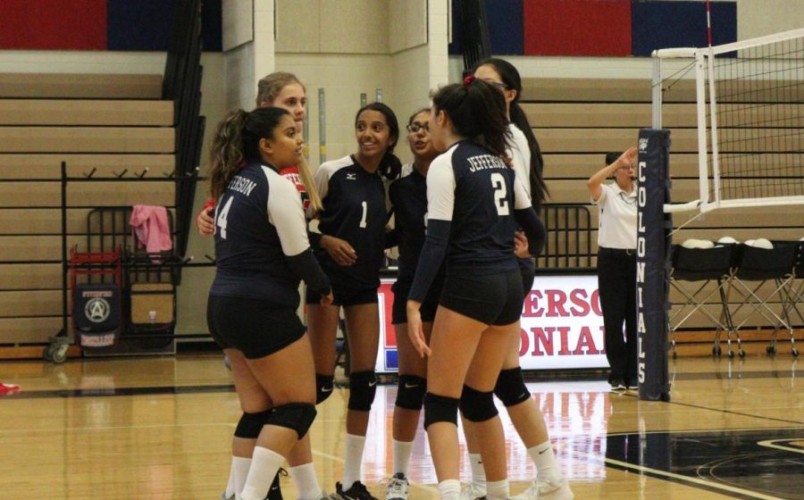 Huddling after tying the Warriors 25-25, the Colonials celebrate and prepare for the next point. 
