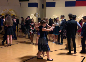 Students waltz to live music performed by the symphonic orchestra at the Viennese Ball. The event lasted three hours, and was filled with music and dancing. Decorations lining the sides of the scene were set up by orchestra students and parent volunteers.
