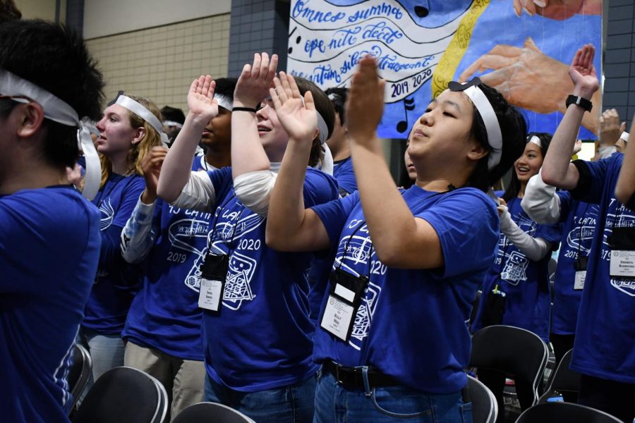 Partaking in a cheer during the 2019 VJCL convention, junior Kelly Mao claps with other Jefferson Latin students