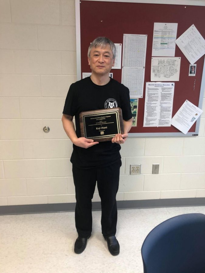 Smiling, Jefferson teacher Kojei Otani poses with his award from the AATJ