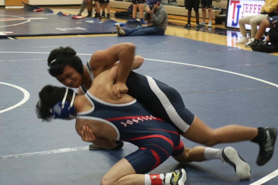 Getting his arm under his opponent, sophomore Ahmad Barokah attempts to drive him into the ground. Barokah, who was down eight and in danger of losing by technical fall, got the pin and 6 points for Jefferson. 