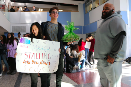 Jefferson wrestling coach Charles Phillips congratulates juniors Brianna Ta and Niko Economos after their asking. "I have a TikTok account that has a mass amount of followers, so she did a compilation of TikTok dances," Economos said. "After my friend led me to Nobel, I was surprised to see the amount of people there. It was a lot of fun and I appreciate it."