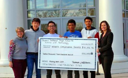 Katherine Phillips (left), sponsor of the SGA, stands with SGA members and a representative of the WCS as the SGA donates the money.