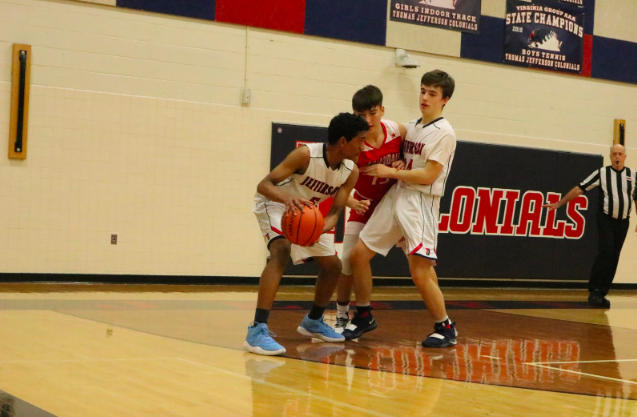 Sophomore Akash Jagdeesh looks to pass the ball while left wing player Steven Li defends the ball against the opponent. After losing their early lead in the second quarter, Jefferson is trying to get back the lead. “Most of the game we were dominating except for this one stretch - our energy was low,” Li said.
