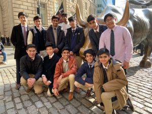 The investment club members pose in front of the Charging Bull statue near Wall Street. The bull has captured tourists’ imagination, Business Insider said. The 7100-pound statue is said to symbolize brazen optimism among investors.