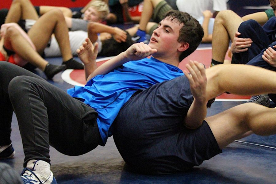 Pinning his opponent to the ground, sophomore Max Vetter learns a new technique during practice 