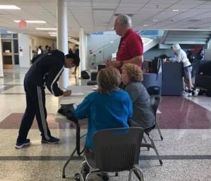 Writing his name down, a student registers to vote on Feb. 3.