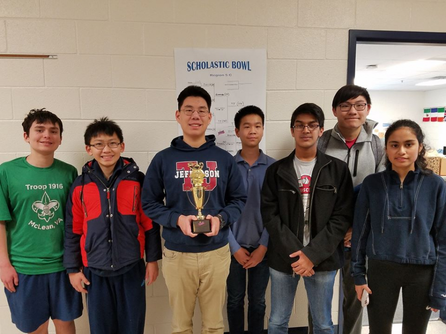 Following+their+victory+at+the+regional+scholastic+bowl%2C+the+Quiz+Bowl+Team+smiles+with+their+trophy