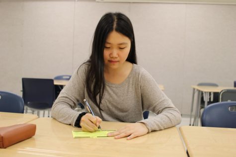 Writing a letter to her legislator, senior Jamie Lee engages in political activisim through her government class.