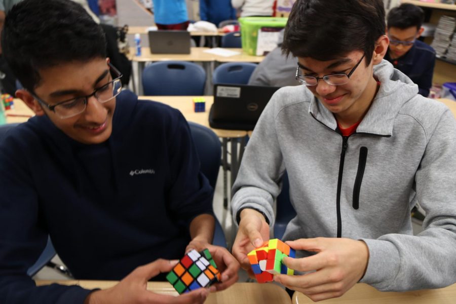 Freshman+Harsha+Ravella+and+sophomore+Michael+Fantemi+cube+together+at+Rubiks+Cube+club.+Fantemi+began+his+cubing+career+during+third+grade+after+watching+his+friend+solve+a+cube.+One+of+my+friends+showed+me+and+I+thought+the+things+is+so+fast%2C+so+I+wanted+to+do+that%2C+Fantemi+said.