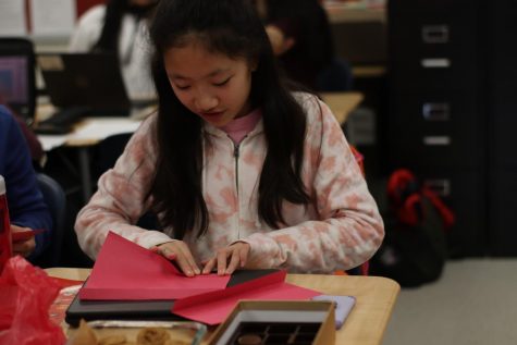 Freshman Cindy Yang folds her lantern. “I went to the Lantern celebration because I wanted to do something fun on Friday.” Yang said.