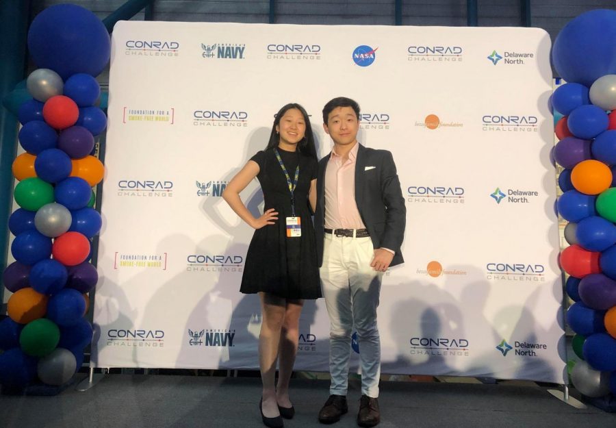 Pan and Yang stand in front of the Conrad Challenge backdrop. The pair submitted their product, BACVision, to multiple competitions during their junior year. Photo courtesy of Motoko Schimizu. 
