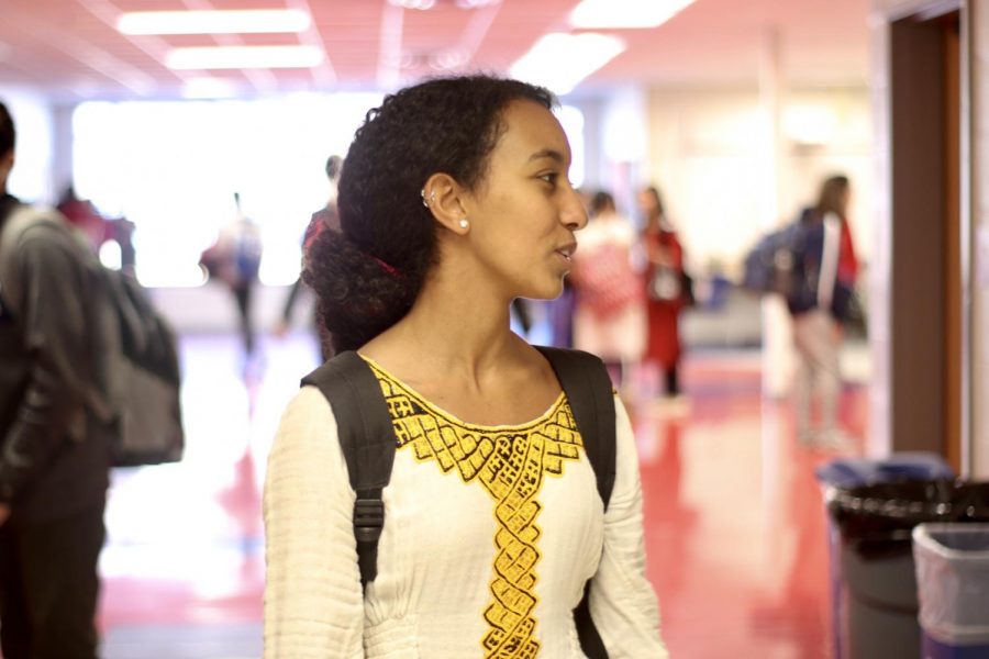 Talking with a friend, sophomore Rahel Selemon wears a traditional Ethiopian dress. TJ International Day gave students an occasion to display their cultural clothing. “There’s no direct translation [of the dress] but ‘habesha kemis’ is close. It’s usually worn with a shawl called ‘netela’ and almost all the dresses will have some kind of ‘cross’ embroidery in various colors,” Selemon said.