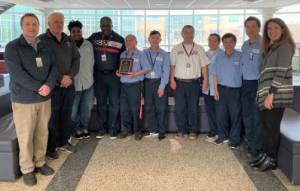 The custodian staff poses for a picture along with Dr. Bonitatibus, director of student activities Berkely hodges, and Manager of Plant Operations Andrew McCracken.
