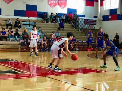 Dribbling up the court, freshman point guard Justin Yoo prepares to shoot with 43 seconds left on the clock during the second period. “One of our strong points was our offense and we scored a lot due to our offensive plays,” Yoo said.
