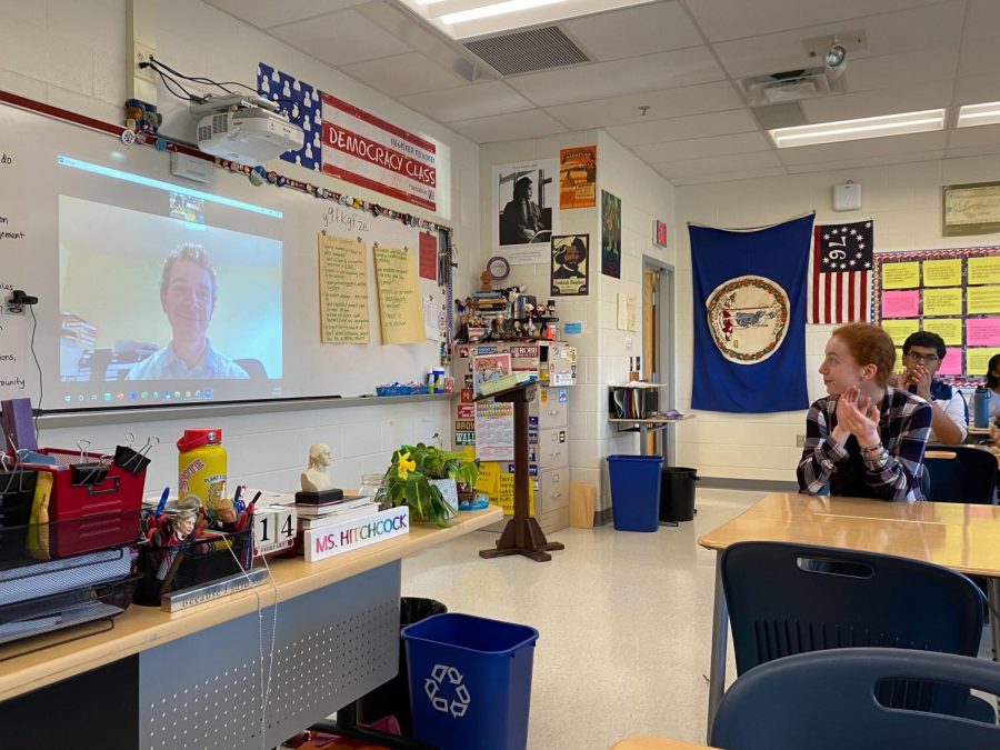 As the FaceTime session concludes. senior Rayna Schoenberger applauds Nate Bellinger, a litigant for Juliana vs. U.S.