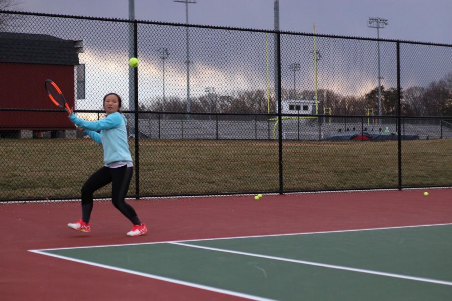 Sophomore Yeefay Li prepares to return a ball. “Tryouts were difficult because the weather was so unpredictable - for example, it was raining and snowing on Friday, so court conditions were really bad,” Li said.
