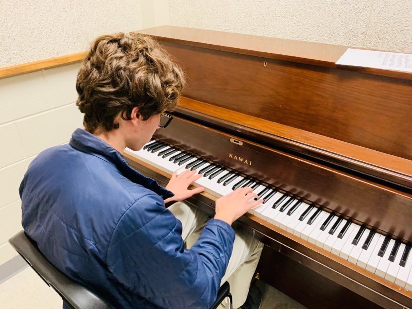 Pressing down on the piano keys, senior Robert Crotts improvs a slow melody 