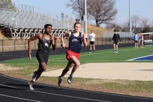 Sprinting down the track, senior Tucker Stanley competes in the 4x800 relay