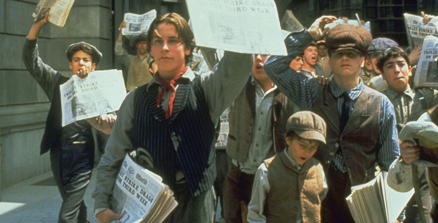 Jack Kelly and his other newsies spreading awareness of the strike of newspaper boys, demonstrating the power of the press, protest, and the voice of the people.