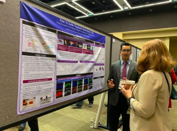 Junior Shan Lateef presents his groundbreaking research on traumatic brain injury to a judge at the 2019 Virginia Academy of Science symposium.