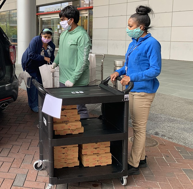 Junior Arul Nigam prepares to bring food into a hospital as part of his initiative ‘Heroes of COVID’. Courtesy of The Connection. 