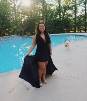 Senior Michelle Pham poses for her individual prom picture in front of her pool.